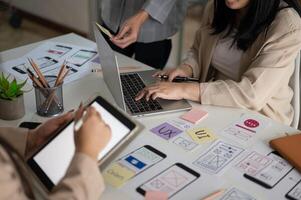 Group of graphic designer in the meeting, brainstorming and planning their new project together. photo