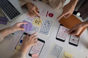 Top view image of a UX UI graphic designer team voting a perfect prototype in the meeting. photo