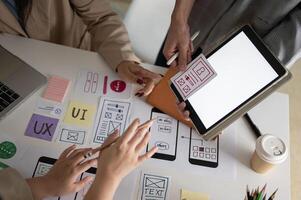 Close-up image of a graphic designer team is in the meeting, looking at a digital tablet screen. photo