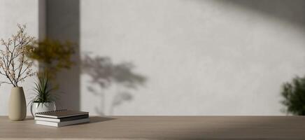 Books, flower vases, and a copy space on a minimalist wooden table against a minimalist white wall. photo