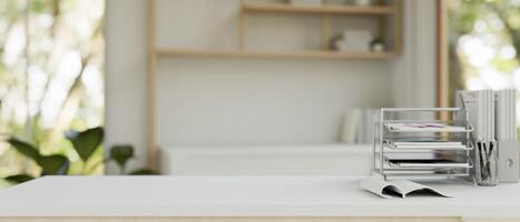 A desk with a document tray, file holders, and space on the table in a modern home office. photo