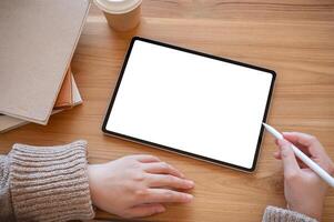 Top view image of a woman using a digital tablet at her desk. people and technology concepts photo