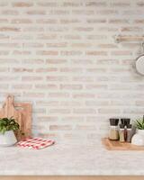 A space for displaying products on a white marble kitchen tabletop against the brick wall. photo