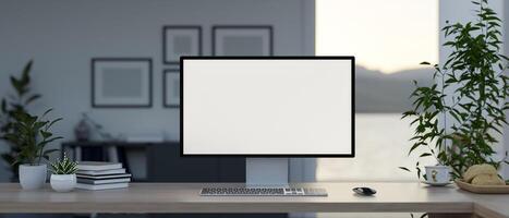 A computer with a white-screen mockup and accessories on a table in a modern private office. photo