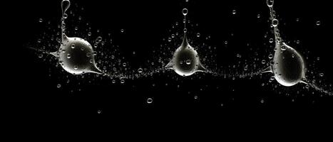 Splashes of water on a black background. photo