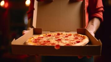 Hands holding a pizza box. Pizza is ready for delivery. . photo