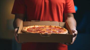 Hands holding a pizza box. Pizza is ready for delivery. . photo