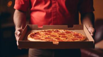 Hands holding a pizza box. Pizza is ready for delivery. . photo