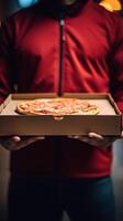 Hands holding a pizza box. Pizza is ready for delivery. . photo