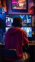 Young black gamer is immersed in computer games with bright neon lighting. . photo