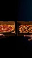 Hands holding a pizza box. Pizza is ready for delivery. . photo