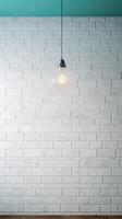 White brick wall with a lamp on the background of stone tiles. . photo