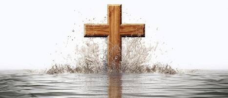 Wooden cross stands surrounded by water. . photo