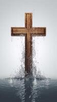 Wooden cross stands surrounded by water. . photo