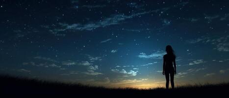 Silhouette of a girl looks at the starry sky. . photo
