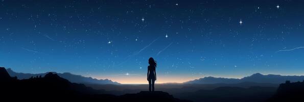 Silhouette of a girl looks at the starry sky. . photo