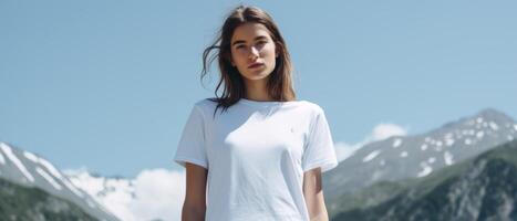 A beautiful girl in a white T-shirt against the background of a beautiful landscape. . photo