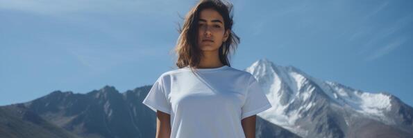 A beautiful girl in a white T-shirt against the background of a beautiful landscape. photo