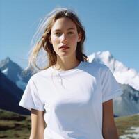 A beautiful girl in a white T-shirt against the background of a beautiful landscape. photo