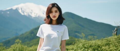 A beautiful girl in a white T-shirt against the background of a beautiful landscape. photo