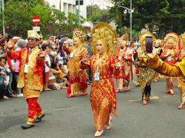 Surakarta City, Central Java, Indonesia, May 15, 2024. Tourist attraction on a traditional costume parade at Slamet Riyadi Street. photo