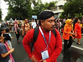 Surakarta City, Central Java, Indonesia, May 15, 2024. Tourist attraction on a traditional costume parade at Slamet Riyadi Street. photo