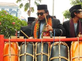 Surakarta City, Central Java, Indonesia, May 15, 2024. Tourist attraction on a traditional costume parade at Slamet Riyadi Street. photo