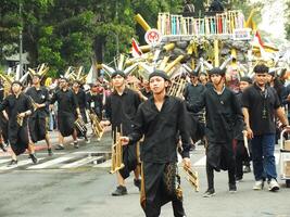 Surakarta City, Central Java, Indonesia, May 15, 2024. Tourist attraction on a traditional costume parade at Slamet Riyadi Street. photo