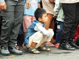 Surakarta City, Central Java, Indonesia, May 15, 2024. Crowd people watching a parade at Slamet Riyadi Street. photo