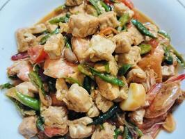 Stir-fry tempeh shrimp, focus of Spicy tempeh cooked in Indonesian styles. Stir fried slicy tempeh,seasoning with shrimp paste with chilies photo