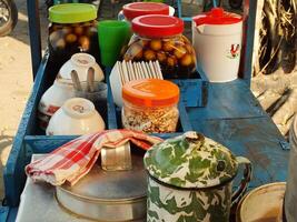 cart selling the traditional Javanese dessert drink wedang ronde. a delicious drink consisting of sticky rice flour filled with peanuts, palm fruit, chopped peanuts and served with ginger syrup. photo