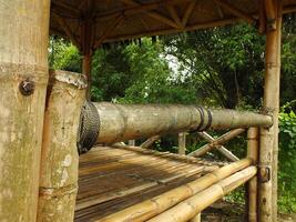 Traditional Bamboo Gazebo in shade under the trees. a relaxing place to unwind photo