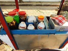 cart selling the traditional Javanese dessert drink wedang ronde. a delicious drink consisting of sticky rice flour filled with peanuts, palm fruit, chopped peanuts and served with ginger syrup. photo