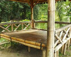 Traditional Bamboo Gazebo in shade under the trees. a relaxing place to unwind photo