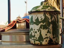 An unique enamel mug with blirik pattern commonly found at java. Used for everyday needs for drink coffee or tea. photo