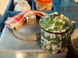 An unique enamel mug with blirik pattern commonly found at java. Used for everyday needs for drink coffee or tea. photo