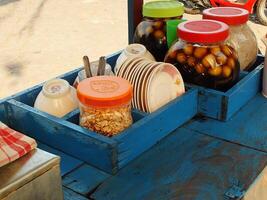 cart selling the traditional Javanese dessert drink wedang ronde. a delicious drink consisting of sticky rice flour filled with peanuts, palm fruit, chopped peanuts and served with ginger syrup. photo