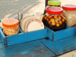 cart selling the traditional Javanese dessert drink wedang ronde. a delicious drink consisting of sticky rice flour filled with peanuts, palm fruit, chopped peanuts and served with ginger syrup. photo