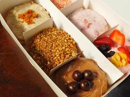Delicious assorted various of donuts with cream, powder glazes and toppings. National donuts day concept. Doughnuts cake. Food and beverage image for coffee shop and restaurant business photo