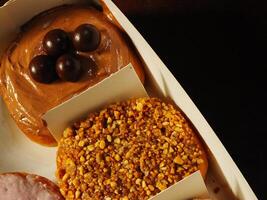 Delicious assorted various of donuts with cream, powder glazes and toppings. National donuts day concept. Doughnuts cake. Food and beverage image for coffee shop and restaurant business photo
