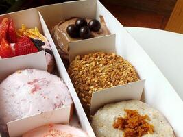 Delicious assorted various of donuts with cream, powder glazes and toppings. National donuts day concept. Doughnuts cake. Food and beverage image for coffee shop and restaurant business photo