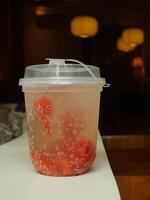 fresh and cold strawberry soda with ice isolated on blurred interior cafe shop. fresh drink for summer day. Food and beverage image for coffee shop and restaurant business photo