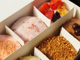 Delicious assorted various of donuts with cream, powder glazes and toppings. National donuts day concept. Doughnuts cake. Food and beverage image for coffee shop and restaurant business photo