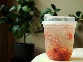 fresh and cold strawberry soda with ice isolated on blurred interior cafe shop. fresh drink for summer day. Food and beverage image for coffee shop and restaurant business photo