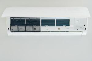 Air conditioner unit with opened front cover ready for maintenance photo