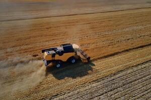 Combine harvester working in agricultural field. Harvest season photo