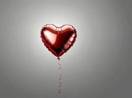 A red heart-shaped foil balloon with a shiny surface, floating against a gray background photo