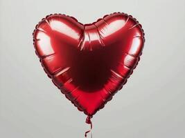 A red heart-shaped foil balloon with a shiny surface, isolated on a neutral background photo