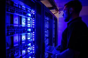 Man standing in front of a data centre checking the database photo