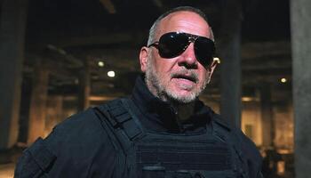 photo of older commander soldier in combat armor outfit on mission scene night ,